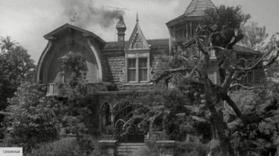The Munster Mansion from the front, just outside the front gate, in black and white