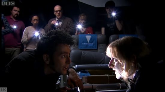 Creepiest Doctor Who stories: Midnight. Image shows the Tenth Doctor and other passengers speaking to a mysterious being on a space bus.
