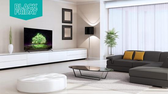 A living room with an OLED LG TV in it, there's a sofa, a table and a small stool. To the top left of the frame is a Black Friday flag.