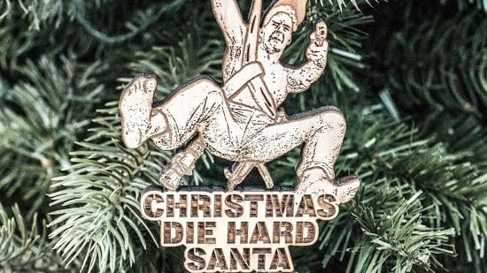 A Die Hard Christmas ornament based on the character John McClane. It has the words "Christmas Die Hard Santa" on it.