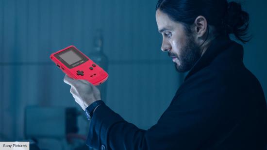 Jared Leto as Michael Morbius in Morbius, with a Game Boy in his hand