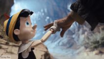 Disney Plus Day image showing Pinocchio reaching up and holding Geppetto's hand in the 2022 live action version of the film.