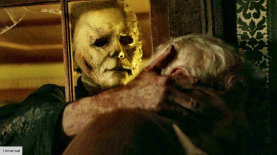 Michael Myers grabbing Laurie Strode in Halloween Kills