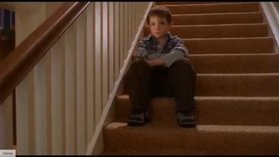 Where to watch Home Alone 4: a still shows Kevin sitting contemplatively on the stairs.