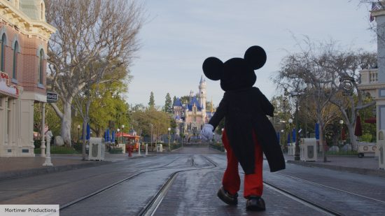 Mickey Mouse: a park greeter walking through Disney Land 