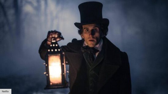The Pale Blue Eye Harry Melling interview: Edgar Allan Poe holding a lamp at night 