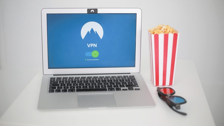 VPN being used to watch movies on a laptop, with popcorn and glasses beside it.