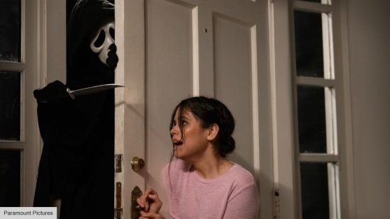 Ghostface explained: Ghostface trying to open a door in Scream 5