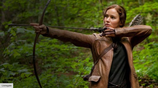 jennifer lawrence as katniss with a bow and arrow in the hunger games