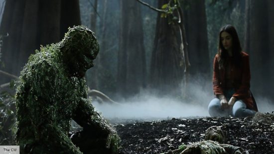 Swamp Thing release date: Swamp Thing sitting with a girl in the woods 