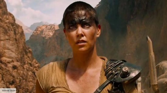 Furiosa release date: Charlize Theron as Imperator Furiosa looking into the distance in the film Mad Max Fury Road 