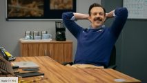 Ted Lasso sitting at a desk