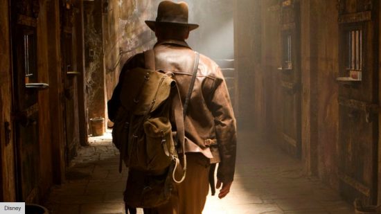 How to watch Indiana Jones 5: Indiana Jones with his back turned walking into a temple 