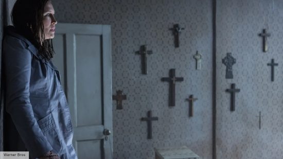 The Conjuring 4 release date: Lorraine Warren standing in a room filled with crosses on the wall 