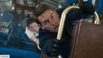 Tom Cruise and Hayley Atwell hanging from a train set after a crash in Mission: Impossible 7