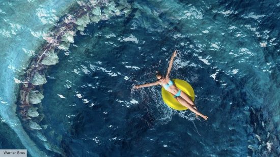 Meg 2 review: a woman on a floatie with a meg in the water 