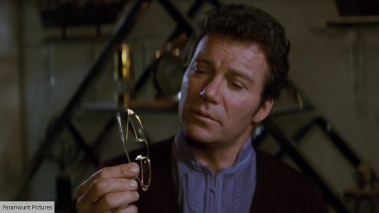 William Shatner as Kirk looking at eyeglasses