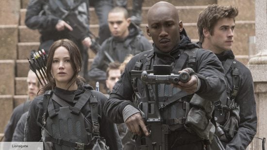 Jennifer Lawrence as Katniss Everdeen, Mahershala Ali, and Liam Hemsworth as Gale in The Hunger Games Mockingjay Part 2
