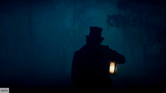 Silhouette from The Pale Blue Eye with figure walking into dark forest: best Netflix movies