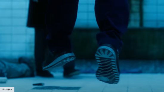 Saw X ending explained: A pair of feet dangling from a trap