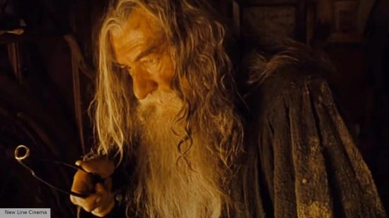 Gandalf holding the One Ring on a chain in the Shire during Lord of the Rings: The Fellowship of the Ring 