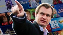 Christopher Nolan standing in front of Christmas movie posters