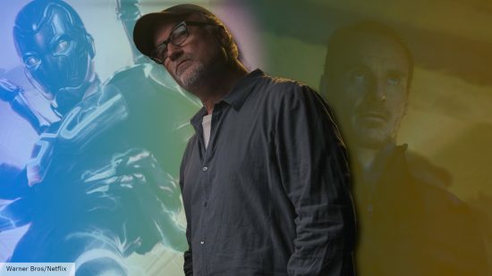 David FIncher stands in front of Blue Beetle and The Killer