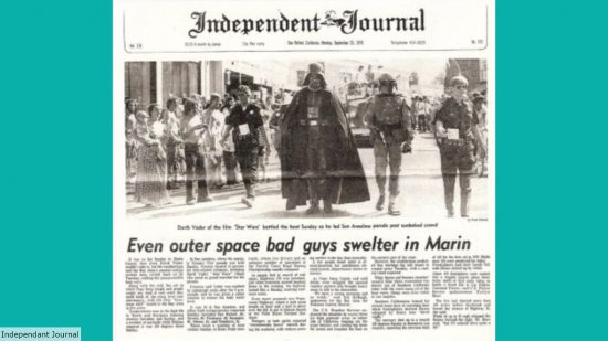 A scan of Independant Journal with a photo of Boba Fett and Darth Vader walking in the parade