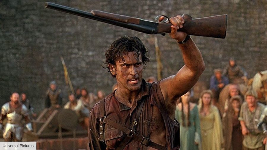Bruce Campbell's Ash holding up a shotgun, covered in mud, during Army of Darkness