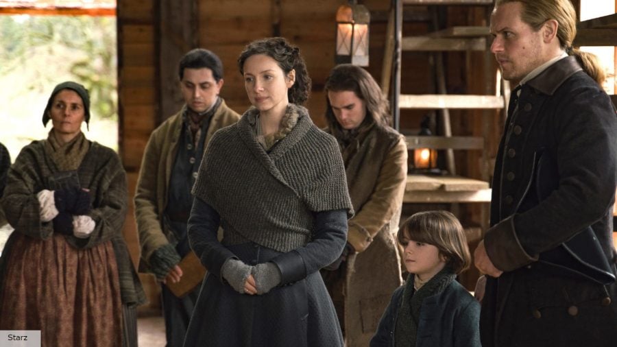 Outlander season 7 release date: Claire and Jamie surrounded by a group of people in Outlander